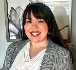 Kiani Hernandez Esq. smiling directly at the camera, a valued member of the Hera Law Group firm team