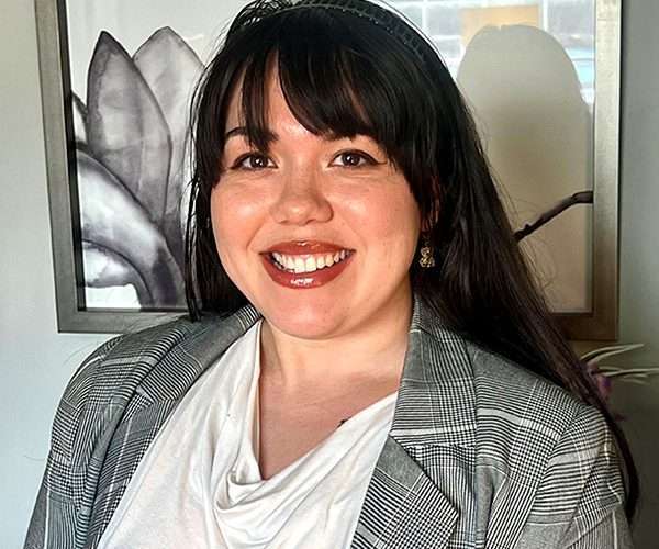 Kiani Hernandez Esq. smiling directly at the camera, a valued member of the Hera Law Group firm team