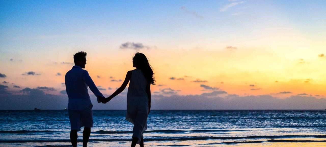 An image of a couple holding hands in the sunset for a blog post on Prenuptial Agreements