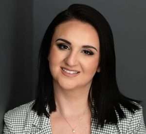 An image of Jamie Narus, Esq., smiling directly at the camera; professional head shot of the practicing attorney.