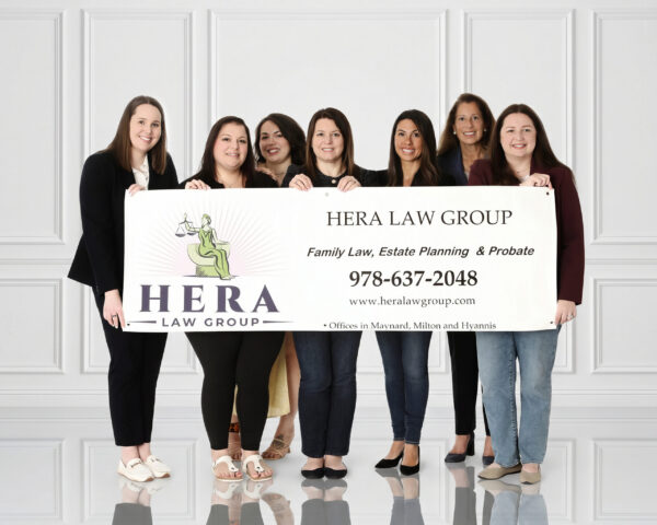 Hera Law Group Photo with members of the firm holding a sign