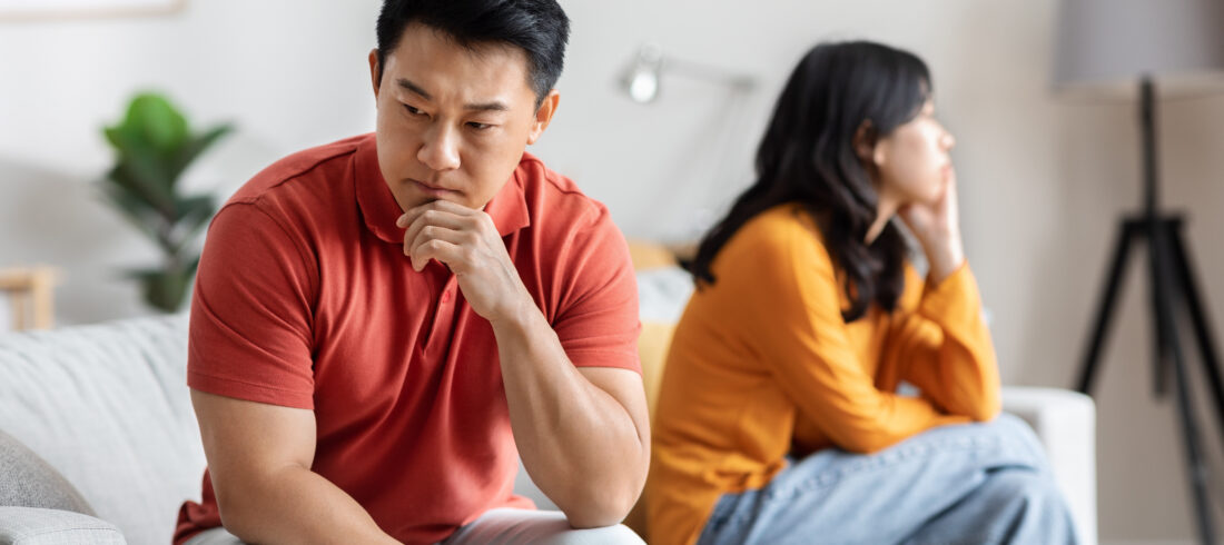 Sad asian man fighting with his lover, home interior