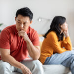 Sad asian man fighting with his lover, home interior